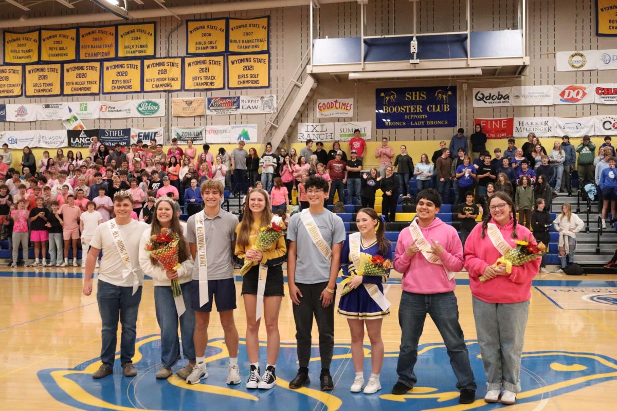 Homecoming royalty poses for a photo at the homecoming pep assembly. 